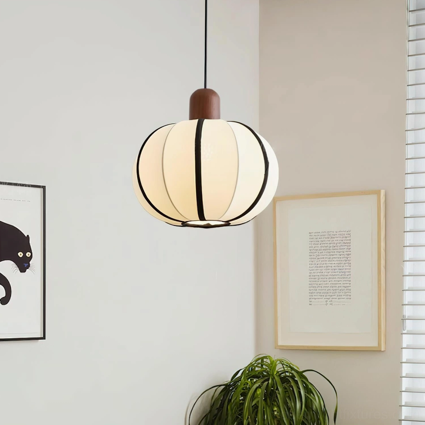 Mosh globe fabric pendant light three-quarter angled view - lit warm glow in japandi rustic minimalist home corner with wall art and potted plant