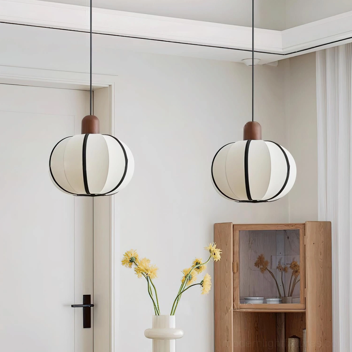 Twin matching Mosh ribbed fabric globe pendant lights - paired installation in modern minimalist white home entryway with neutral warm ambiance