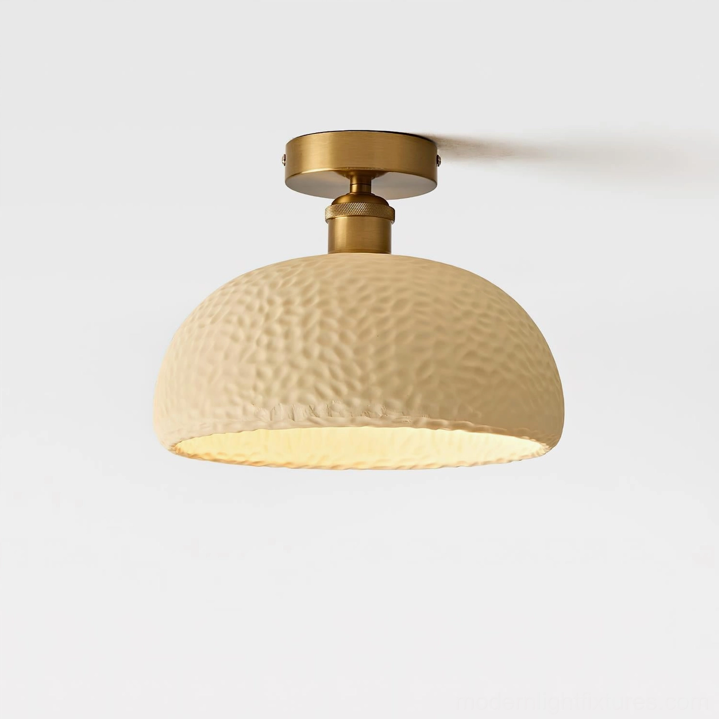 Beige hammered semi-flush ceiling light with brass gold fixture and warm bottom lighting - front close-up