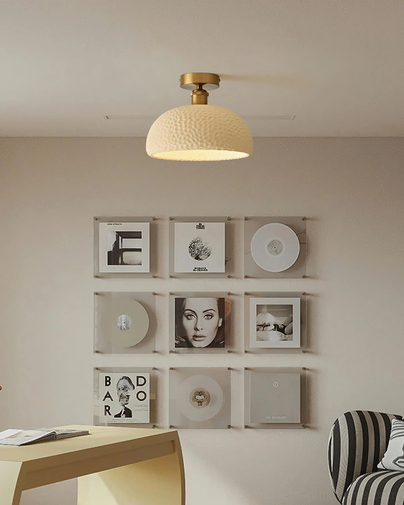 Beige semi-flush ceiling light installed in contemporary home office with wall-mounted art and decor