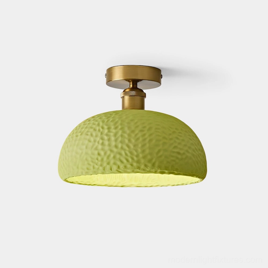 Avocado green semi-flush ceiling light with hammered textured resin shade and brass gold base - front view
