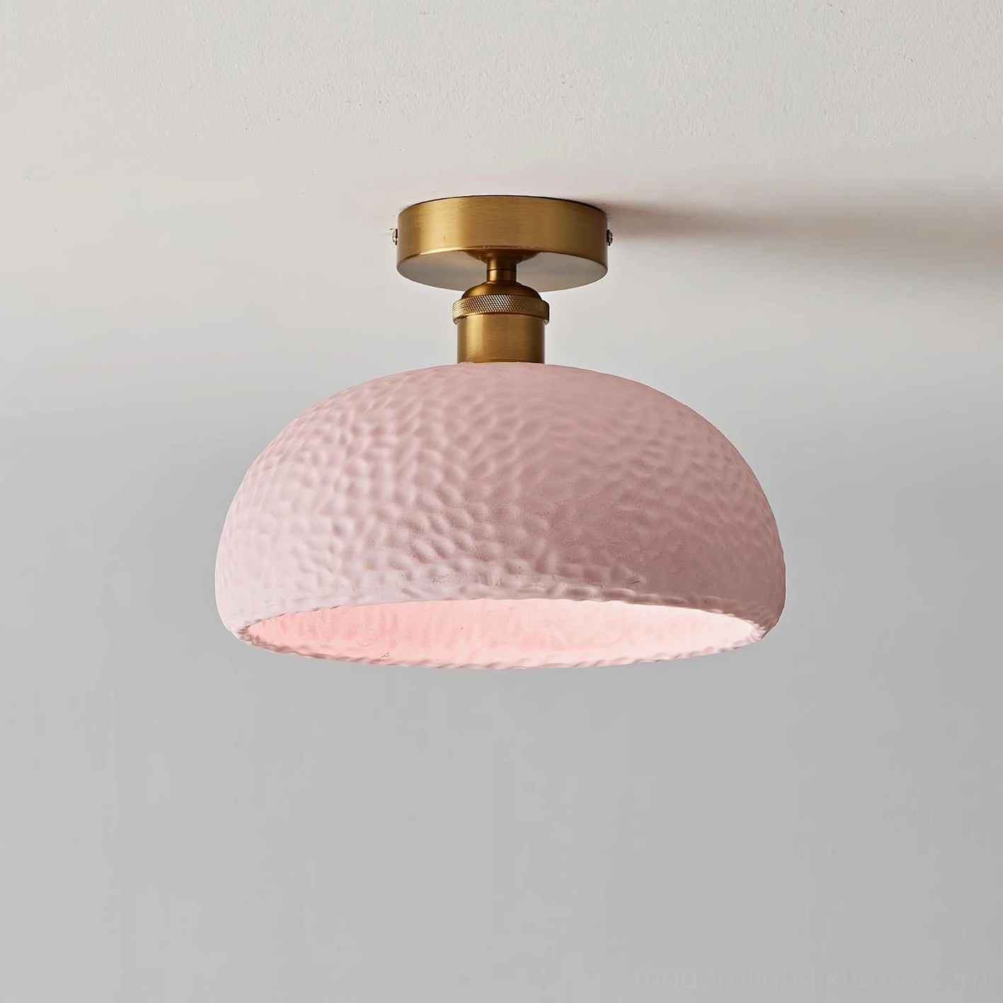 Soft pink hammered semi-flush ceiling light with brass gold base and textured resin shade - front view