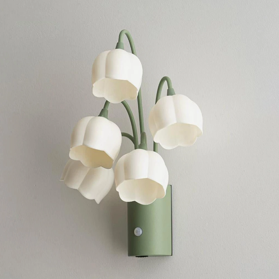 Close-up front view of green and white frosted acrylic flower wall sconce showing bell-shaped shades and metal stem details