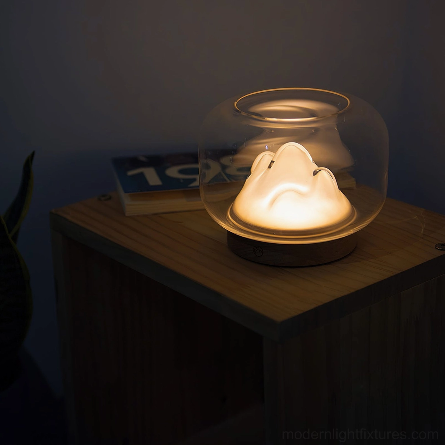 Mountain table lamp bedside nightstand styling, three-quarter view near book, soft warm bedroom lighting atmosphere