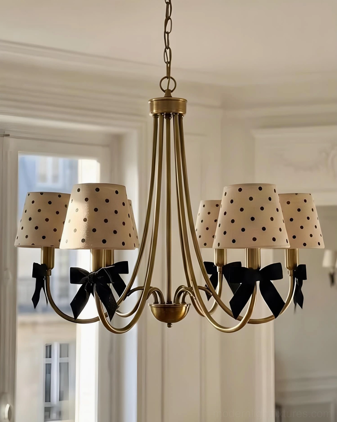 Multi-arm polka dot chandelier in bright French apartment - side interior view