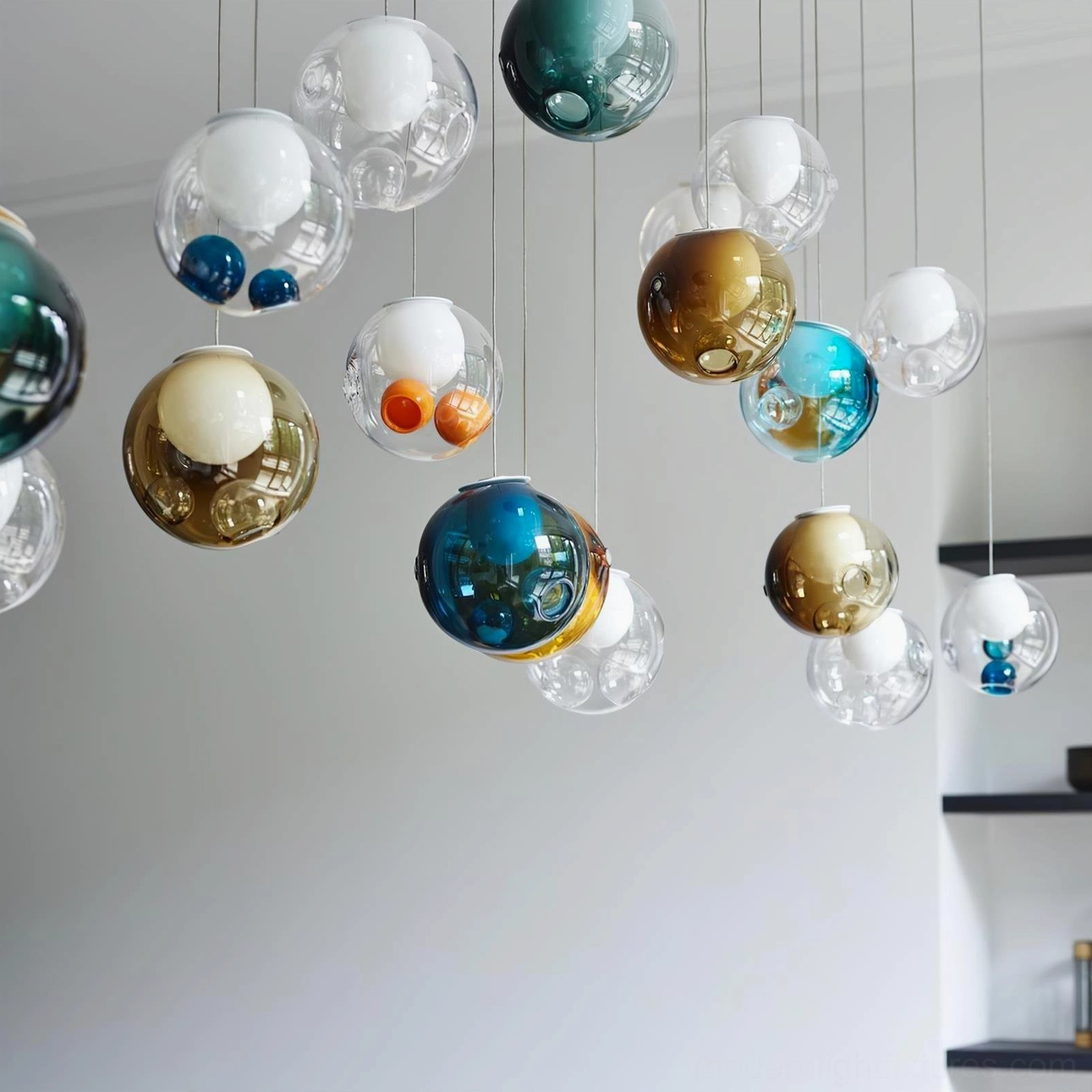 Multi-head glass globe pendant chandelier in modern interior space demonstrating spatial scale and luminous quality