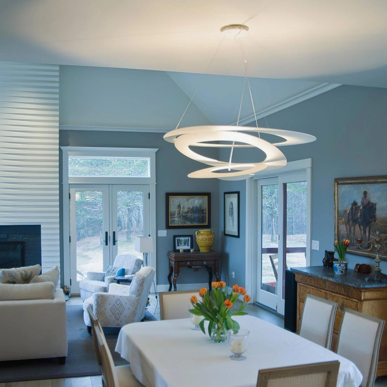 Multi-layer ring pendant chandelier in modern dining room, bright neutral LED illumination with minimalist design