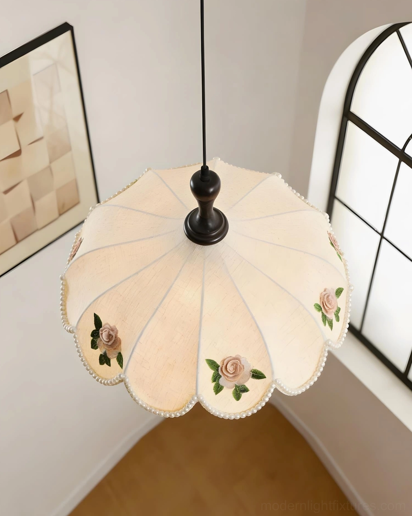 Multi-panel scalloped pendant lamp with rose embroidery motifs displayed in cozy home interior near arched window