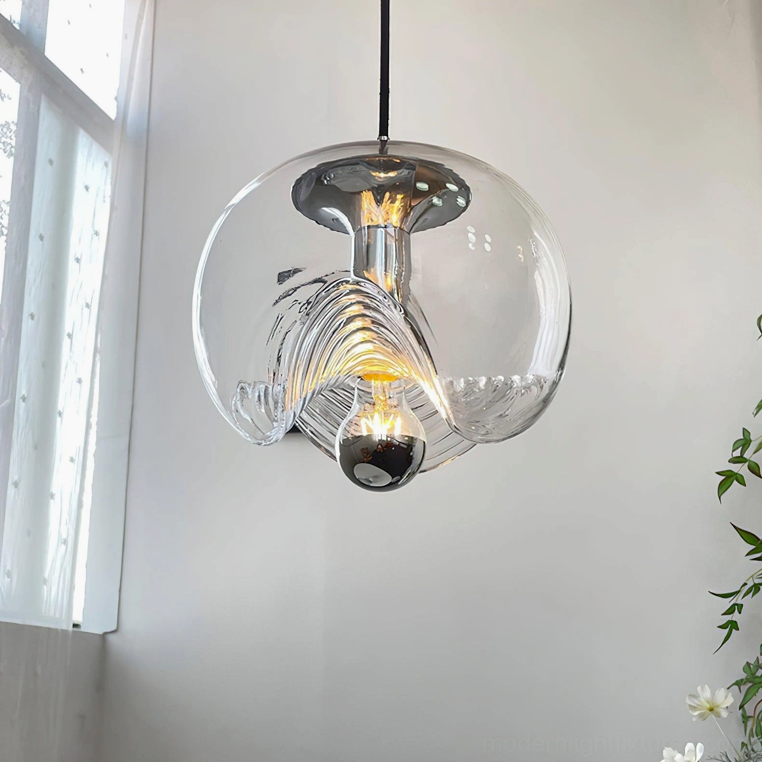 Multi-pendant light installation detail showing wave glass texture and light refraction, modern minimalist fixture assembly view