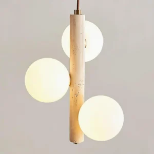 4-sphere travertine pendant light with warm neutral studio backdrop, porous travertine base and milky glass spheres
