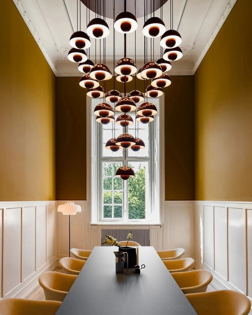 Multi-tiered black and white dome pendant chandelier in formal commercial dining hall with long perspective view, modern luxury interior decor