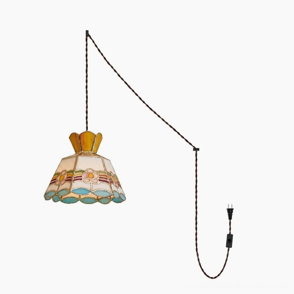 Plug-in pendant light with multicolor hand-cut stained glass shade featuring amber pink blue and green glass panels with copper-foil seams brass frame and braided cord