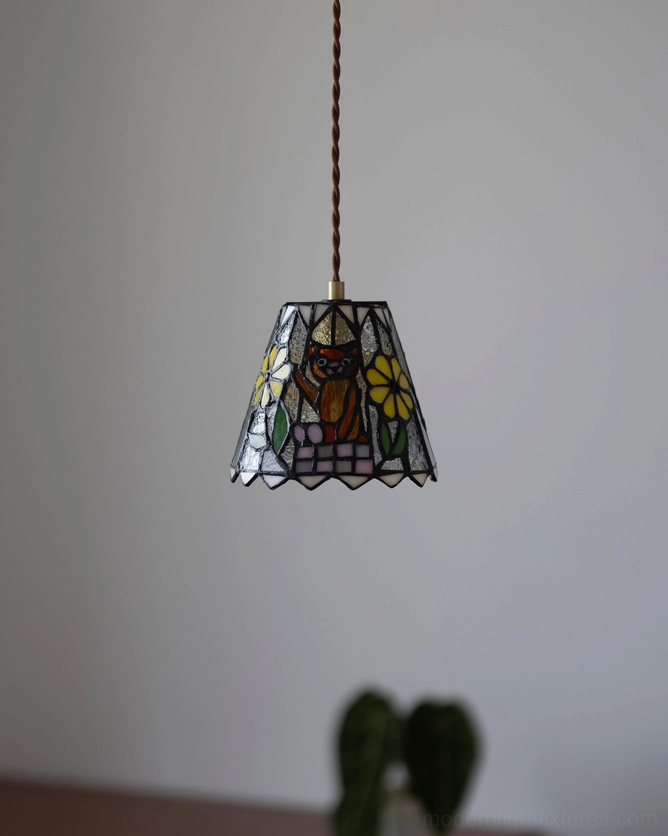 Multicolor stained glass pendant lamp with brass hardware and whimsical character motifs