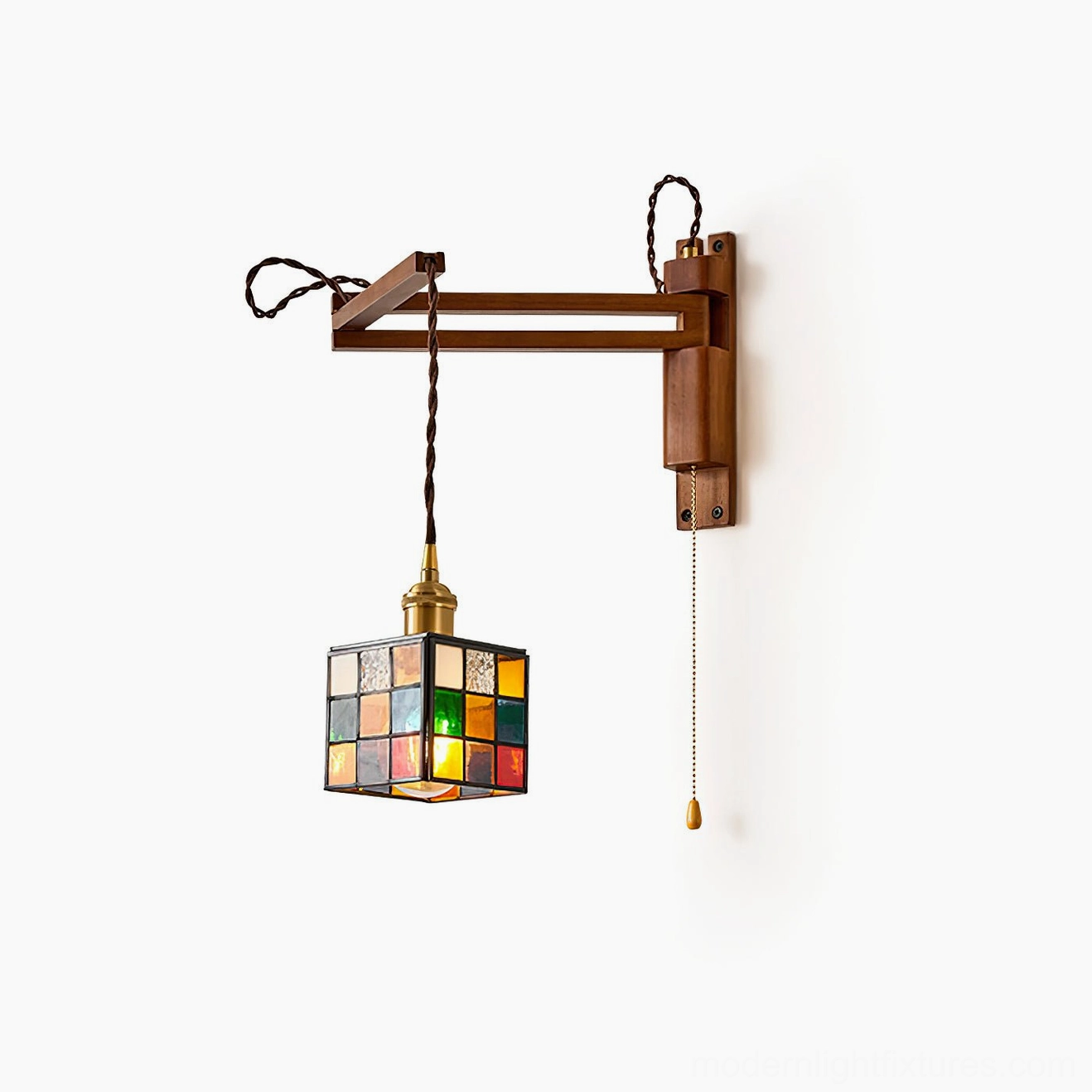 Multicolor stained glass wall sconce illuminated demonstrating jewel-tone mosaic effect with amber, jade, and ruby glass casting decorative light patterns on interior wall