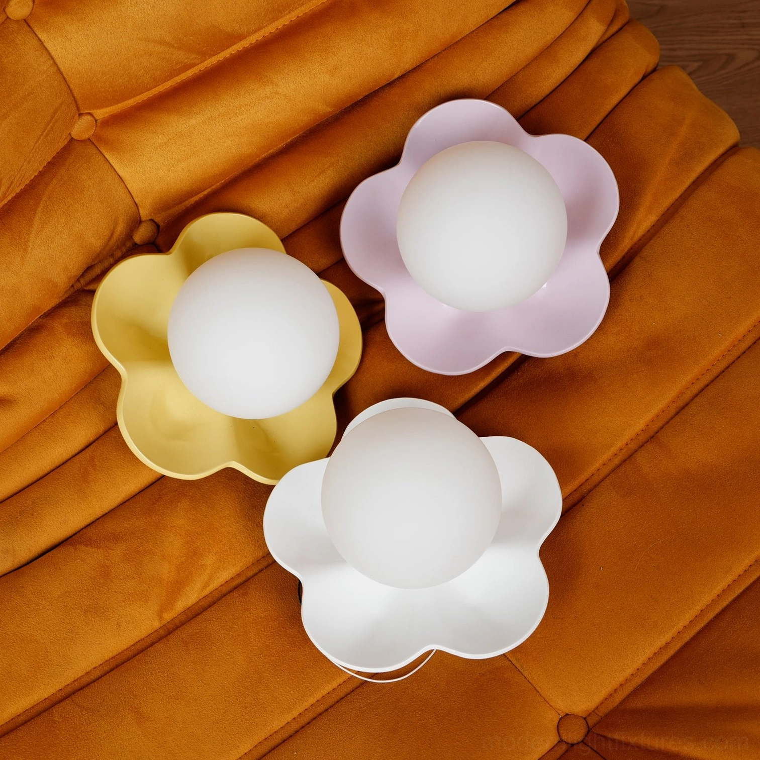 Multiple Fleur wall sconces installed as botanical wall installation - grouped flower lamps create garden-like arrangement
