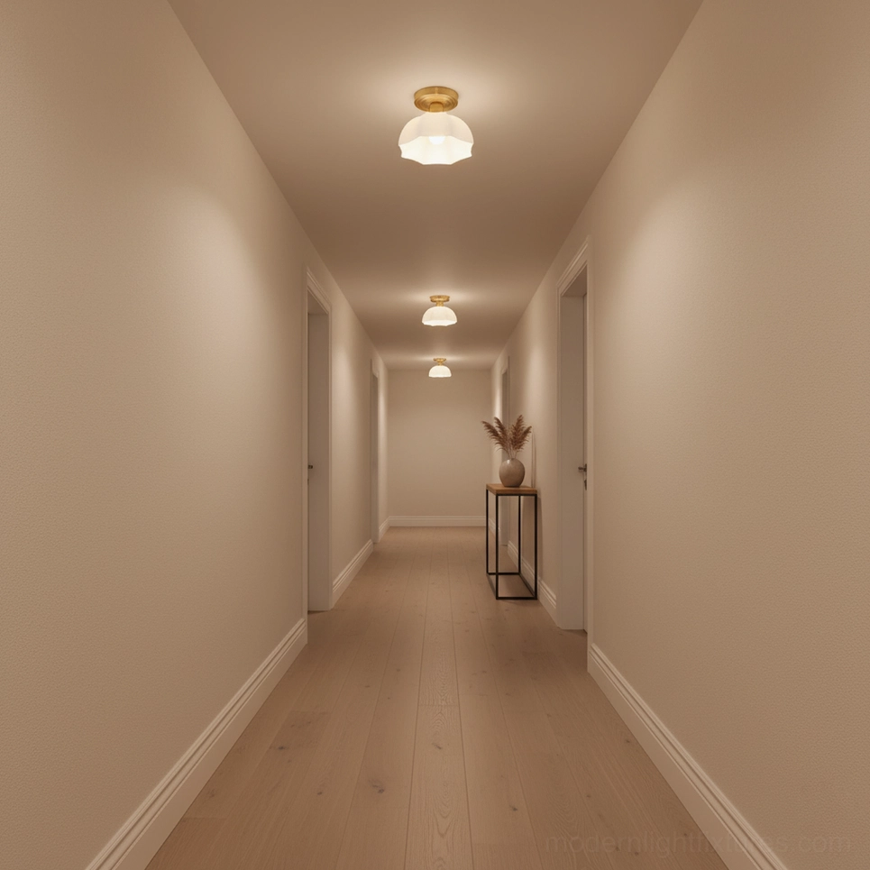 Series of matching scalloped brass semi-flush lights installed in long residential hallway corridor