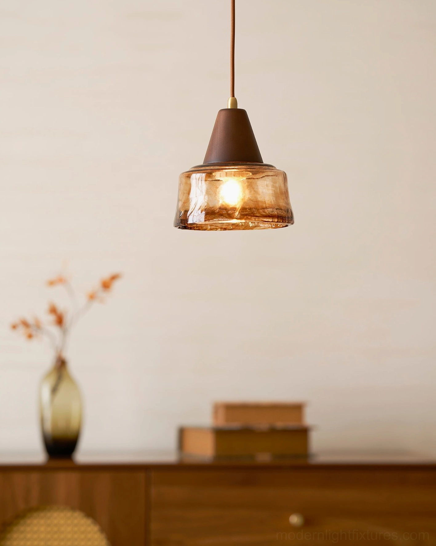 Single Murano amber glass pendant in elegant entryway setting