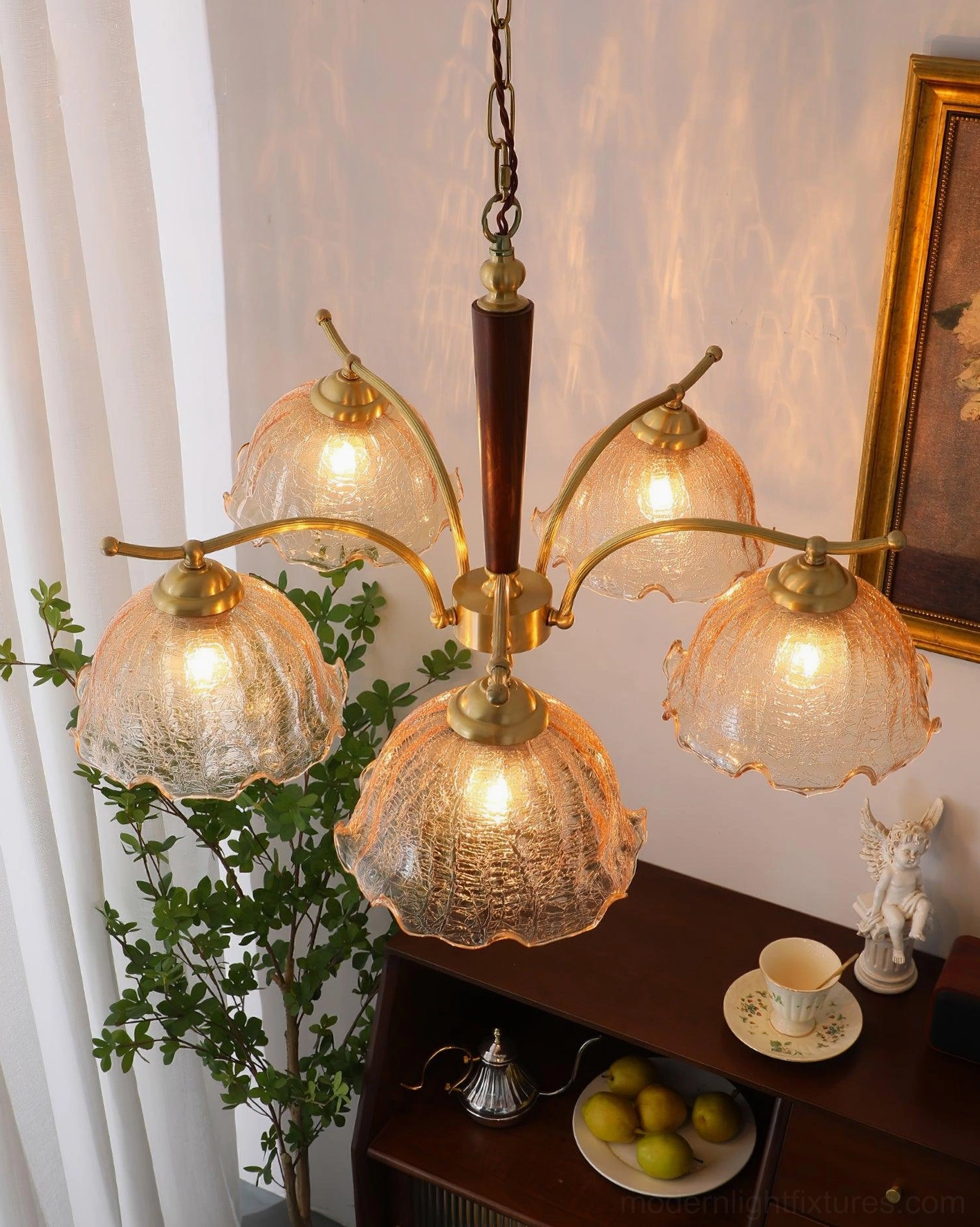 Side oblique view of 5-head vintage Murano chandelier with dark wood central rod, brass arms and lit cognac glass