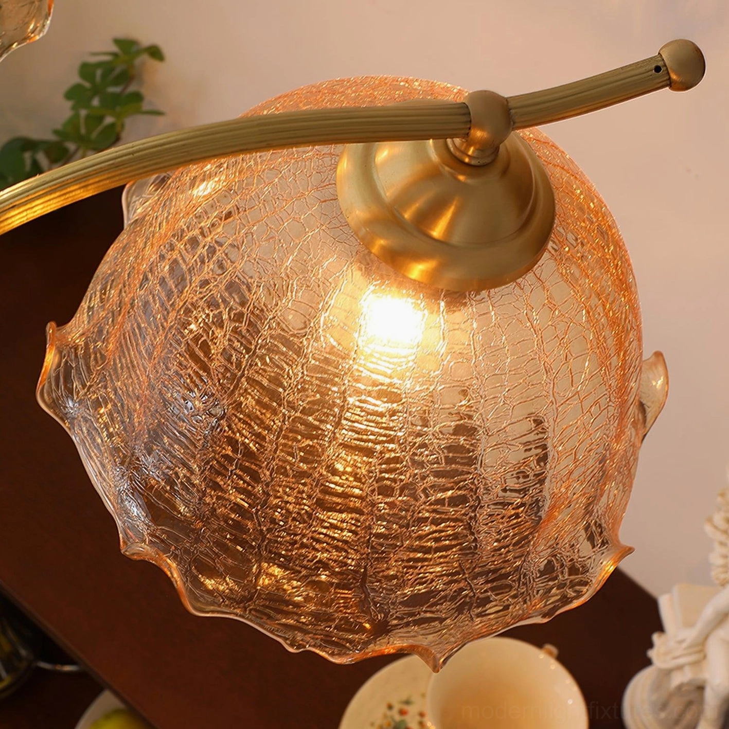 Murano chandelier with textured amber glass shades and brass frame in home interior setting