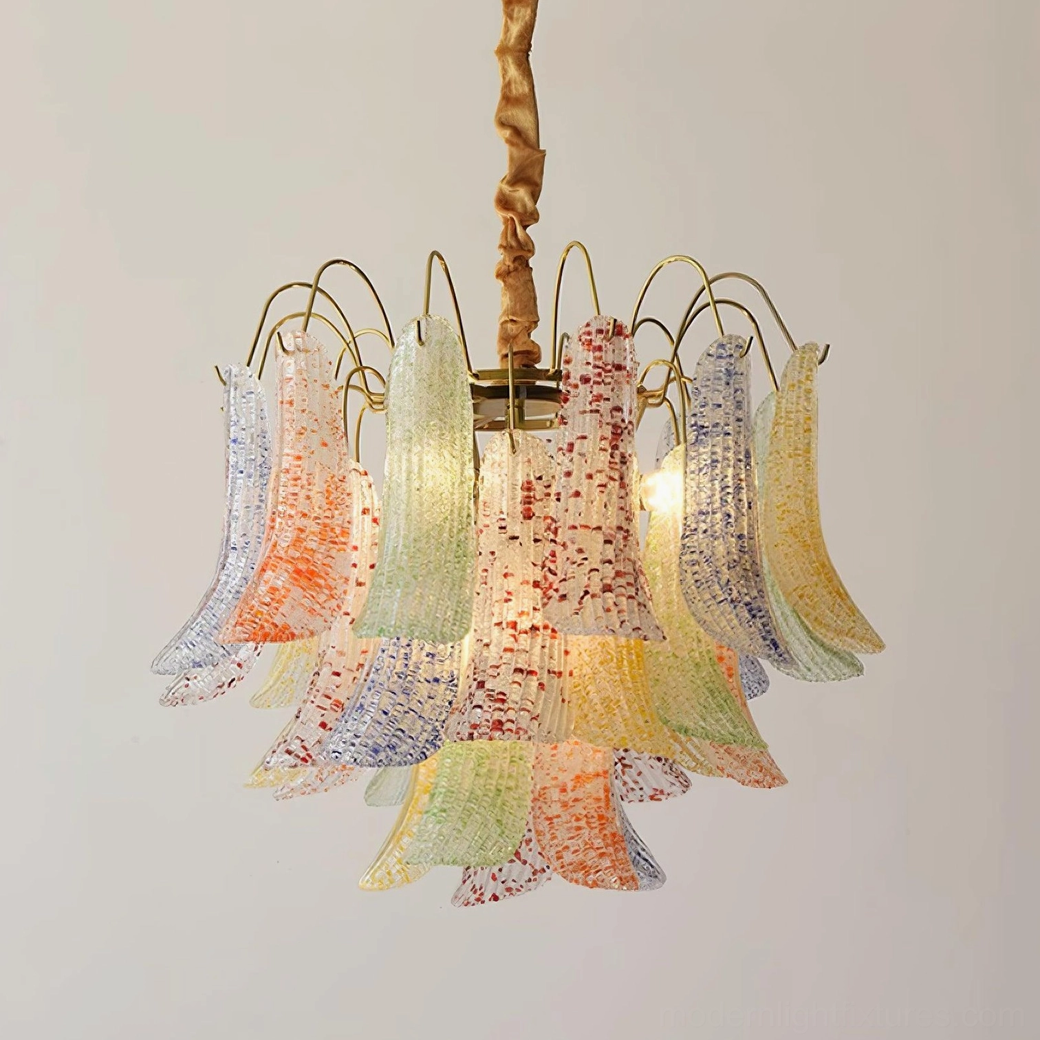 Murano glass chandelier with speckled shades creating warm ambient light in interior space