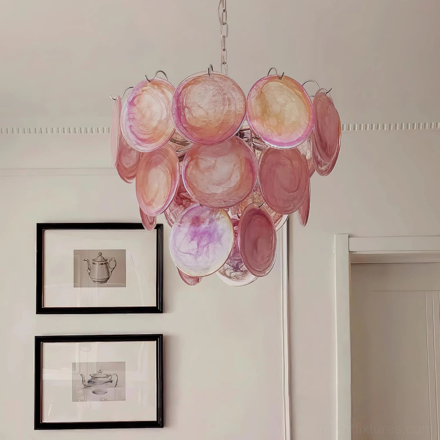Pink Murano glass disc chandelier installed in formal neoclassical living room with framed artworks