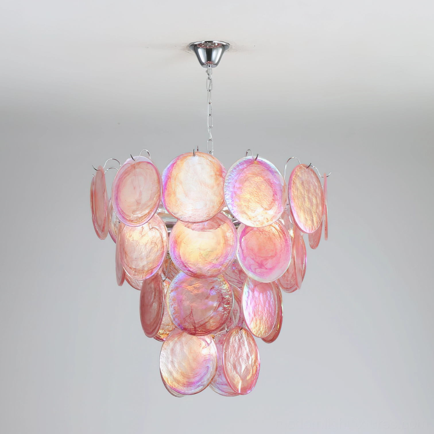 Close-up detail of pink iridescent glass discs in Murano chandelier showing hand-blown craftsmanship and chrome frame