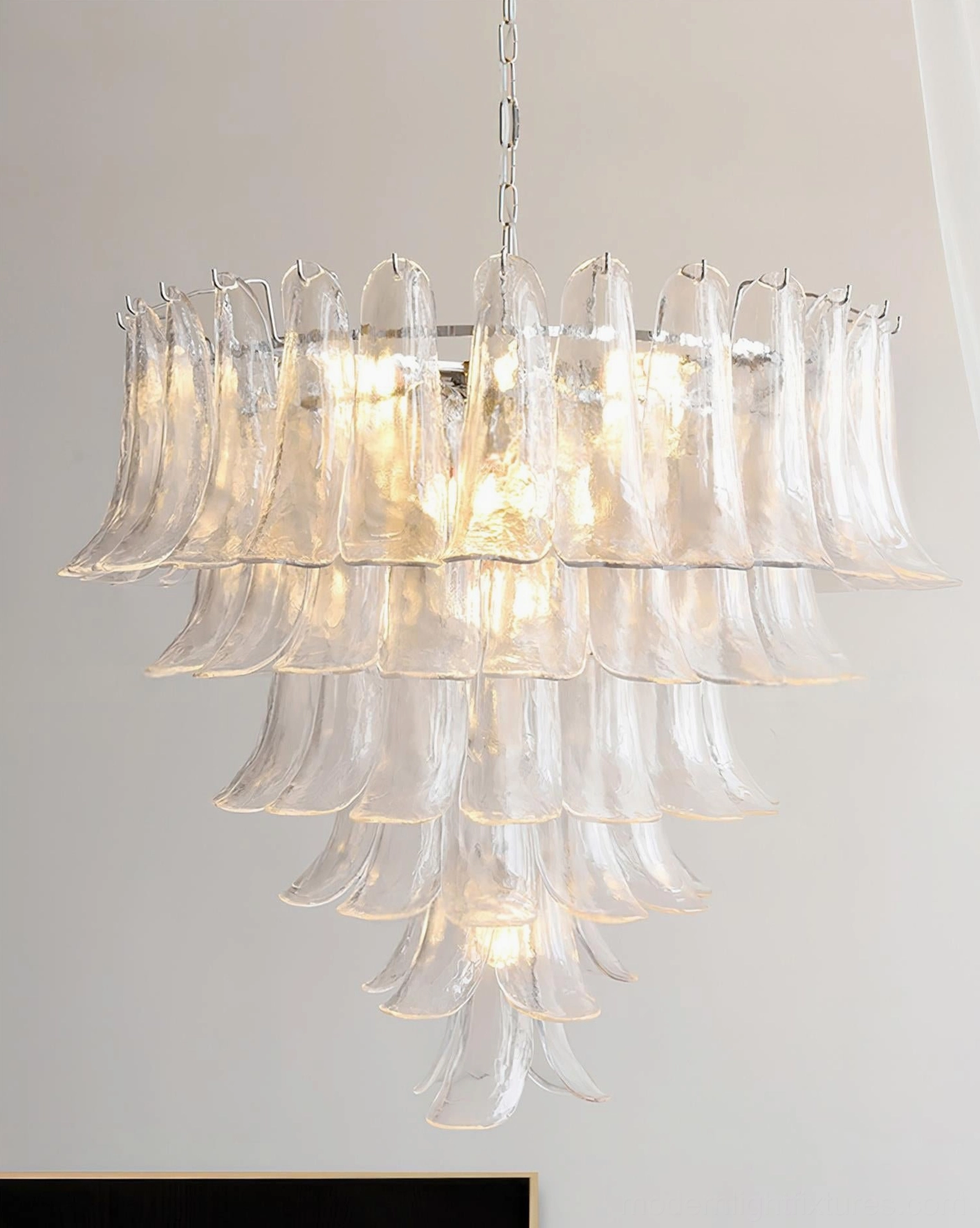 Hand-blown Murano petal chandelier creating soft diffused lighting with artistic glass quality