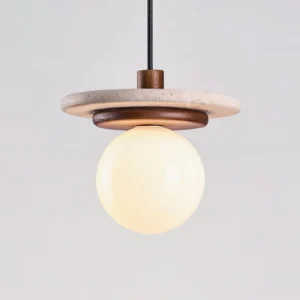 Close-up macro view of Murto pendant showing travertine disc texture and wooden trim detail with illuminated frosted glass