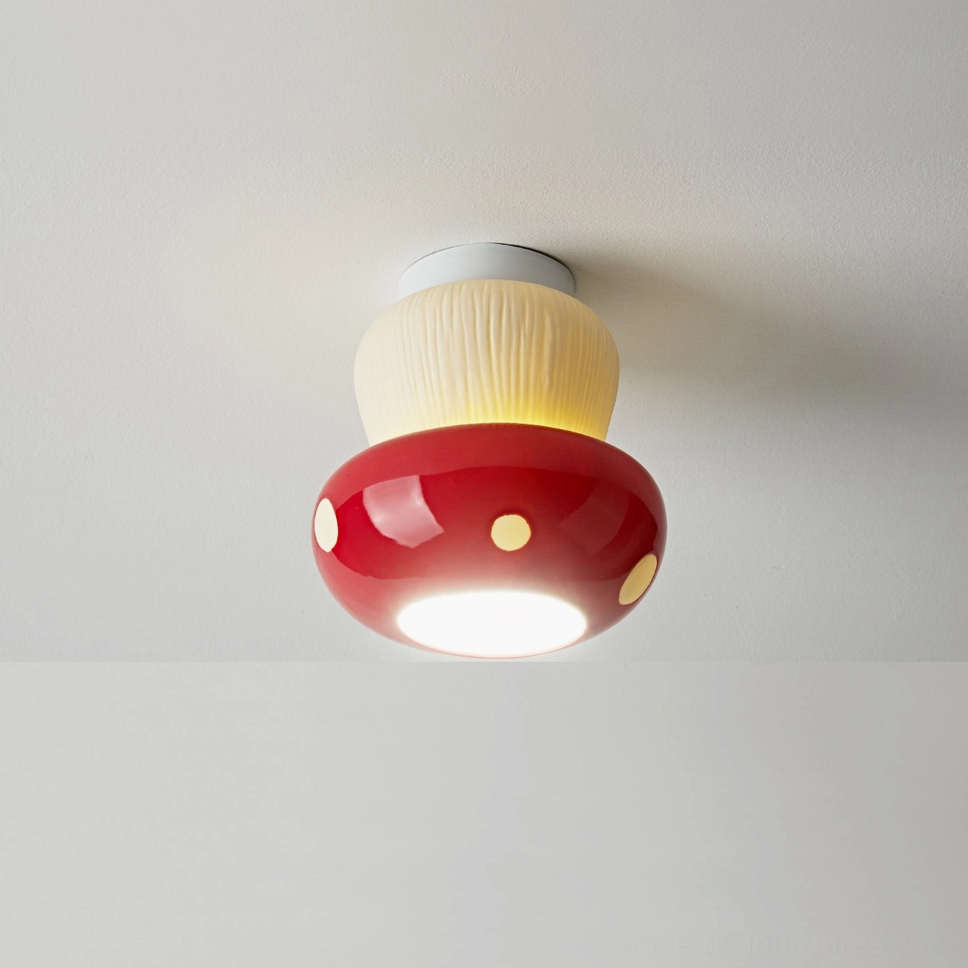 Mushroom-shaped ceiling light fixture detail showing ceramic texture and metal canopy hardware