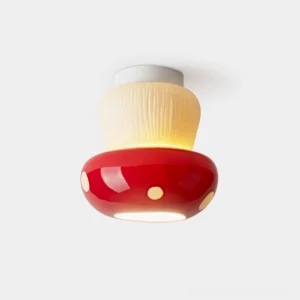 Whimsical mushroom-shaped ceiling lamp with glossy polka dot design on white background front view