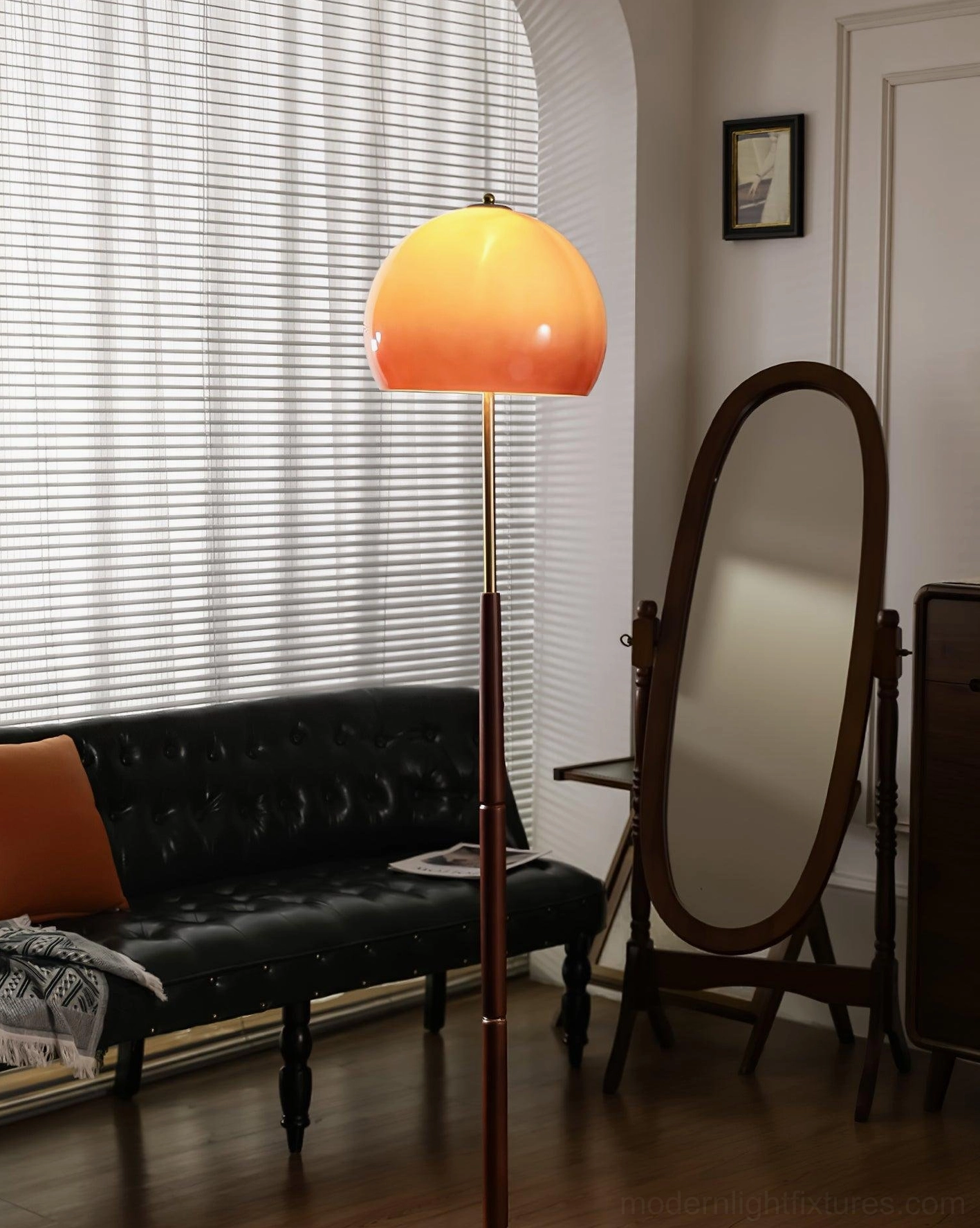 Lit mushroom floor lamp in mid-century modern bedroom setting with full-length mirror and wood flooring