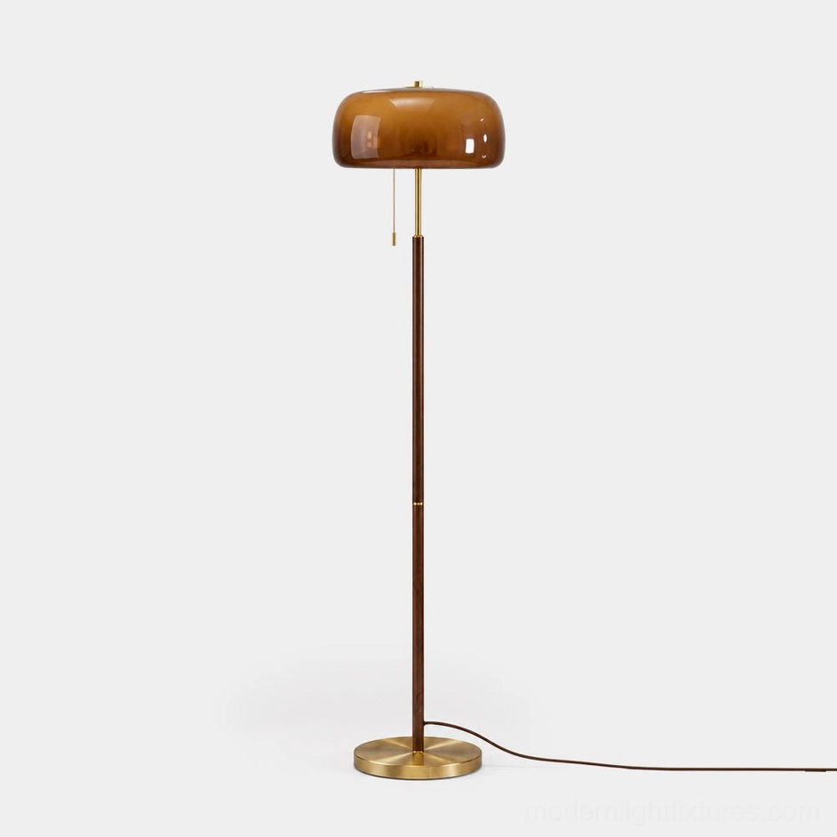 Mushroom floor lamp with brass base and walnut wood stem against white studio background, mid-century modern design