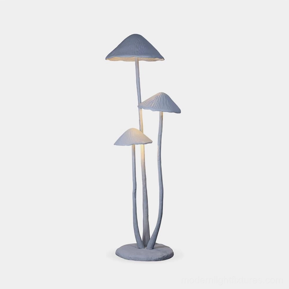 Modern mushroom sculptural floor lamp with three matte gray textured caps in studio lighting, front flat perspective view