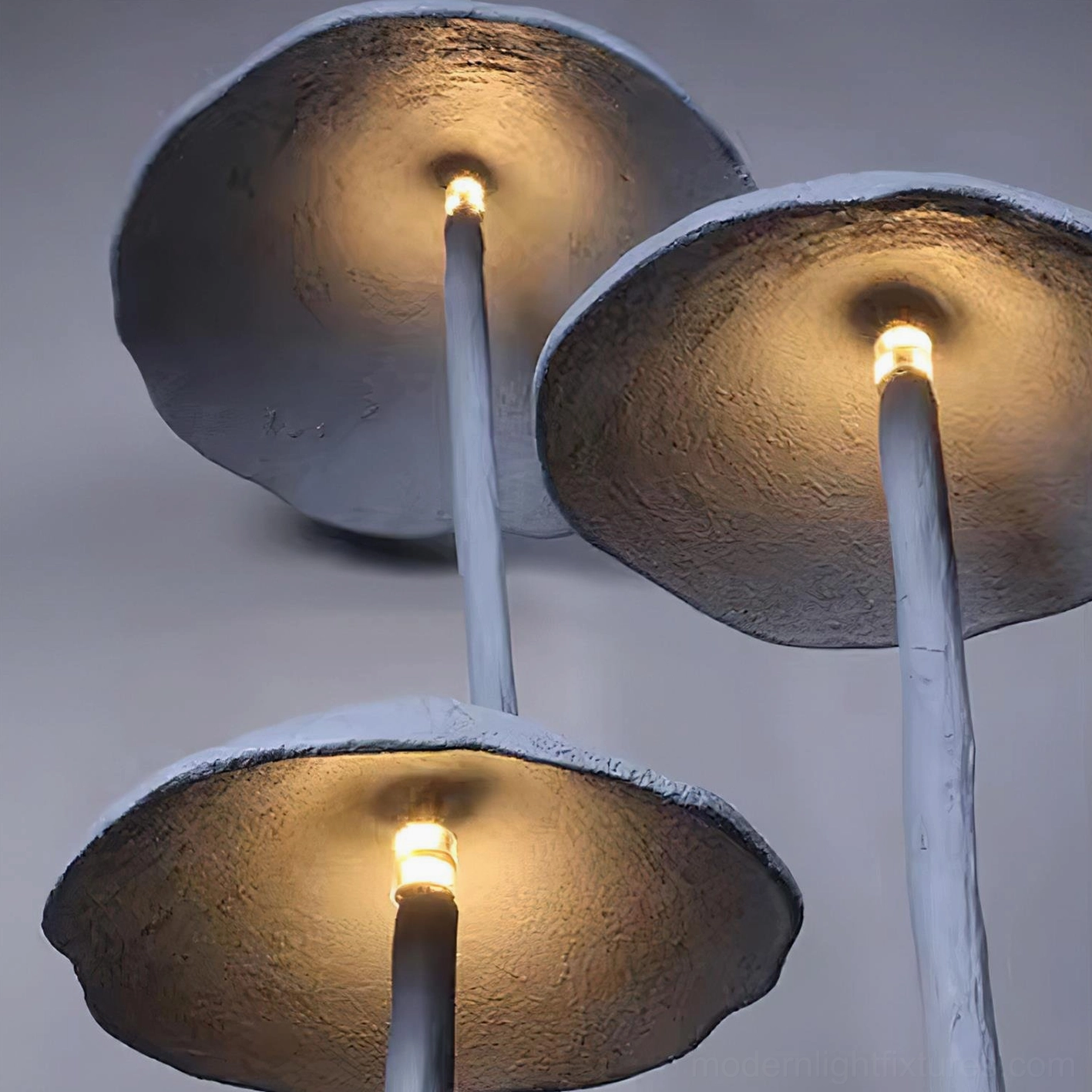 Interior detail of mushroom lamp shade showing warm integrated LED light emission inside matte gray shade, close-up view