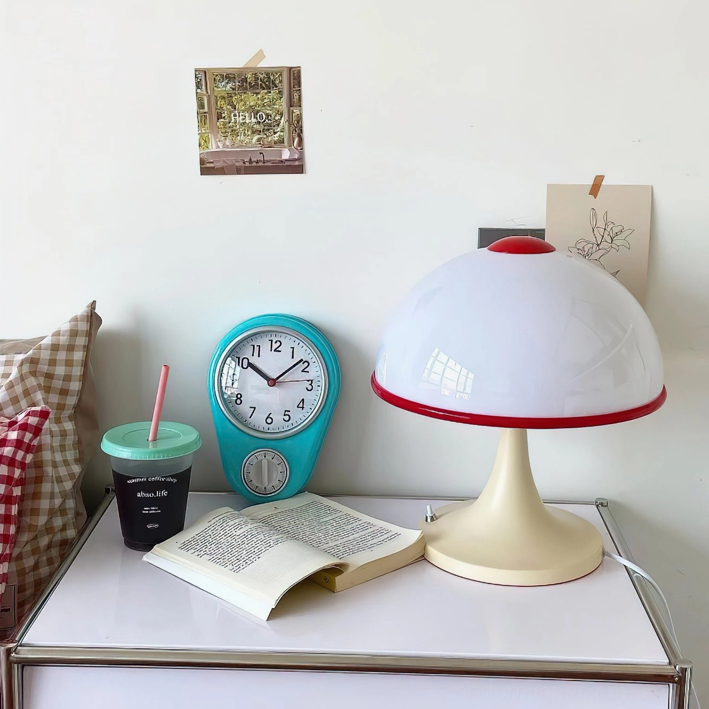 Mushroom lamp bedside table high-angle view bedroom setting with clock and reading materials