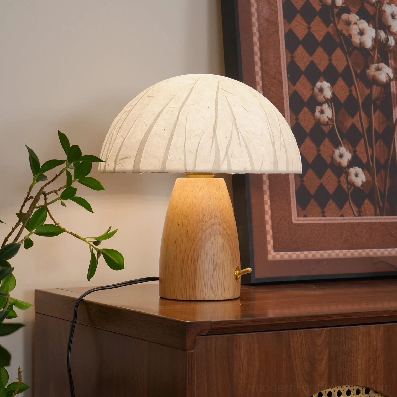 Mid-century inspired mushroom table lamp with light oak base in cabinet with green plants