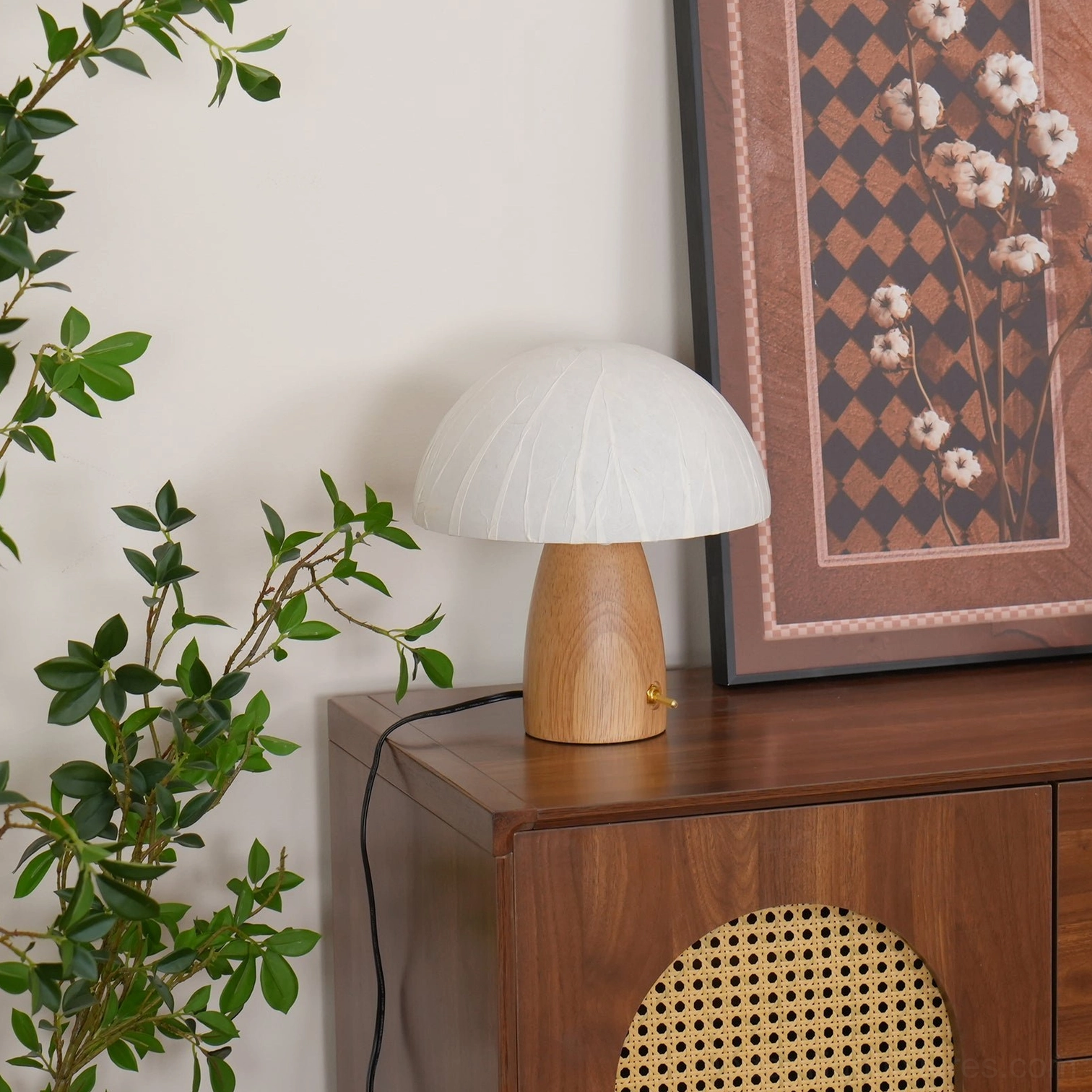 Natural wood base of mushroom table lamp with grain detail and brass switch