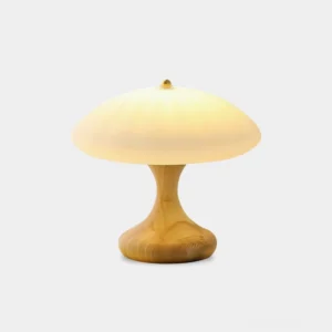 Mushroom table lamp with ribbed frosted glass shade and light wood base on white background, warm glowing light demonstration