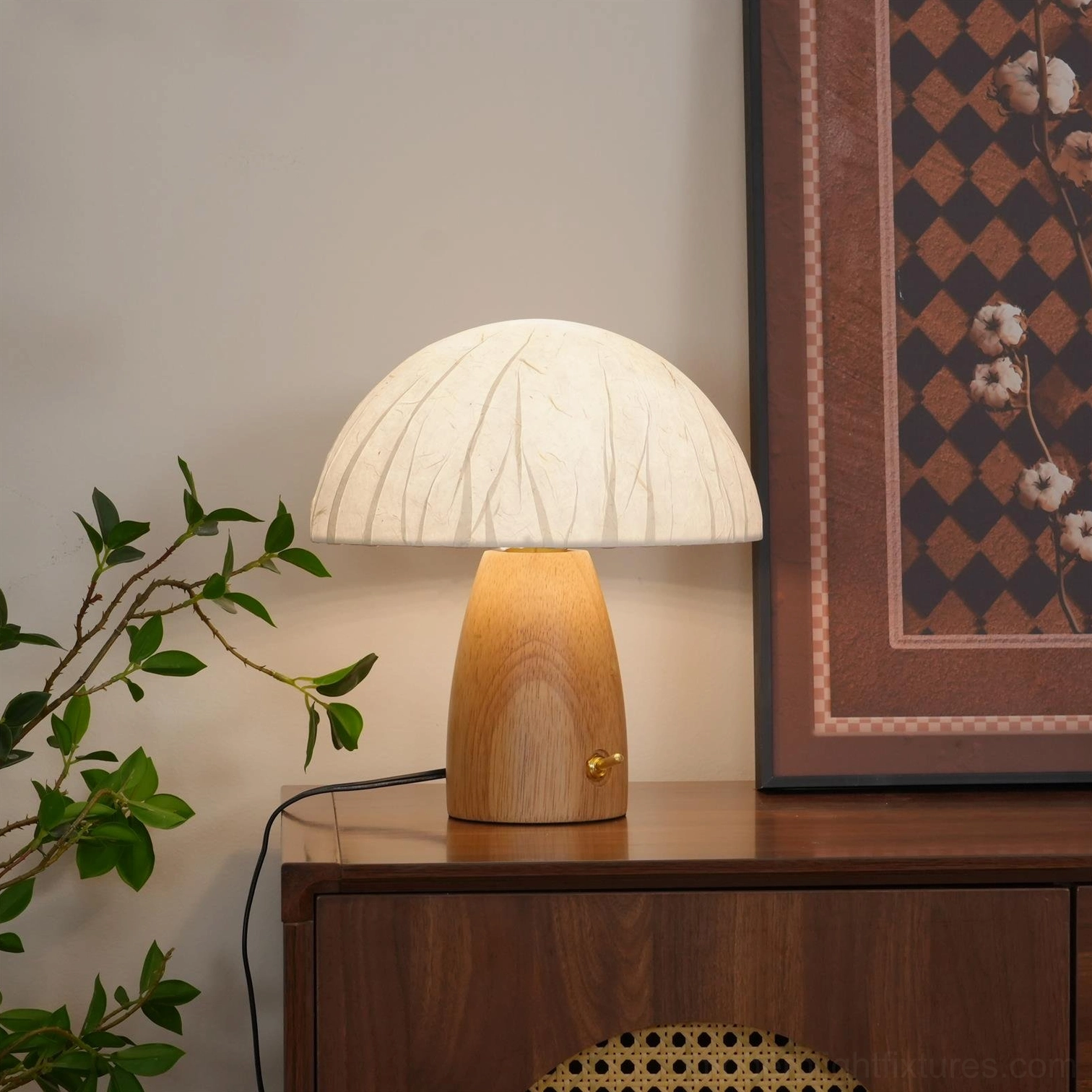 Modern mushroom table lamp in home setting beside wooden cabinet with warm ambient glow