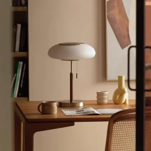 Mushroom table lamp on warm neutral home study desk with walnut furniture, coffee set and decorative accessories - functional desk lighting