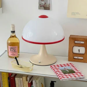 Mid-century modern mushroom table lamp three-quarter view on indoor side table with wine glass and notebook styling