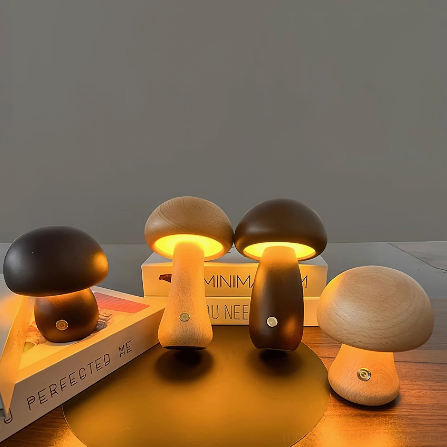 Wooden mushroom table lamps with warm ambient lighting displayed on stacked books with touch controls visible