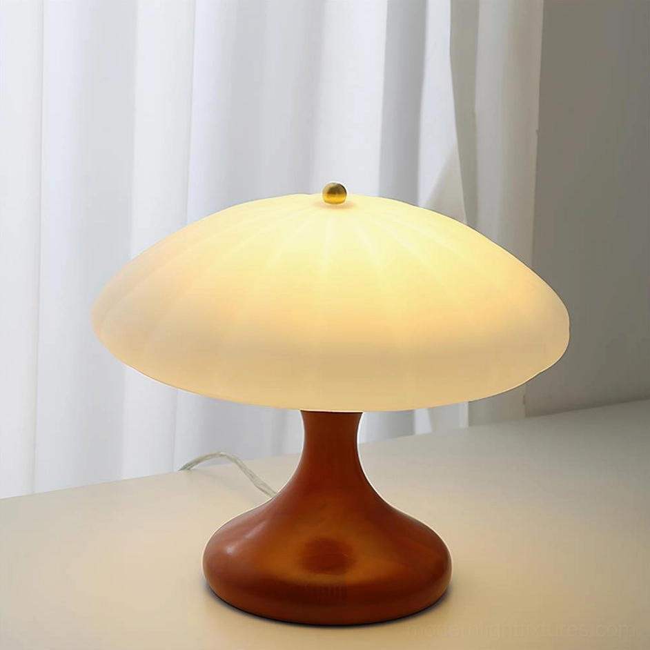 Close-up front view of mushroom table lamp with dark walnut wood base and ribbed frosted shade, illuminated warm lighting detail
