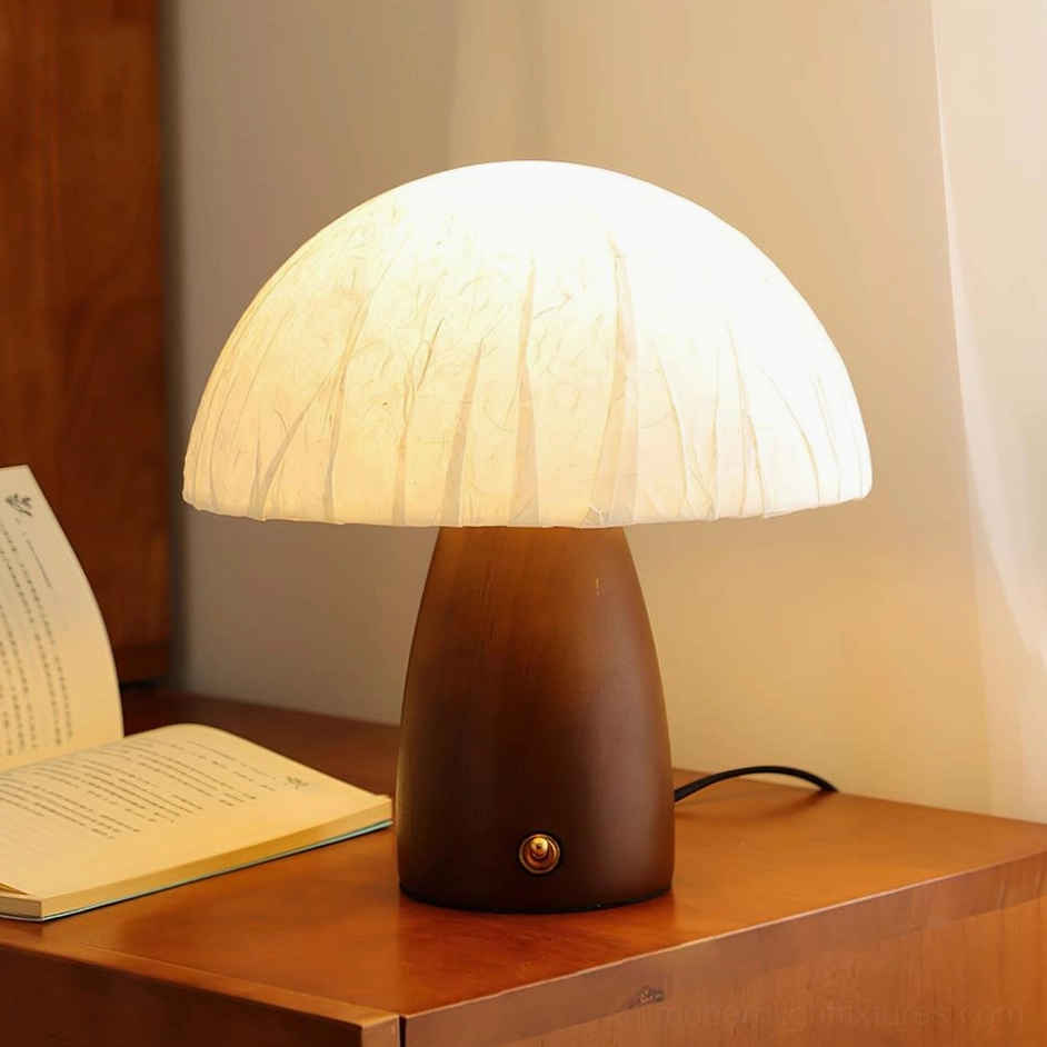 Mushroom table lamp with walnut base on wooden side table with lit warm light