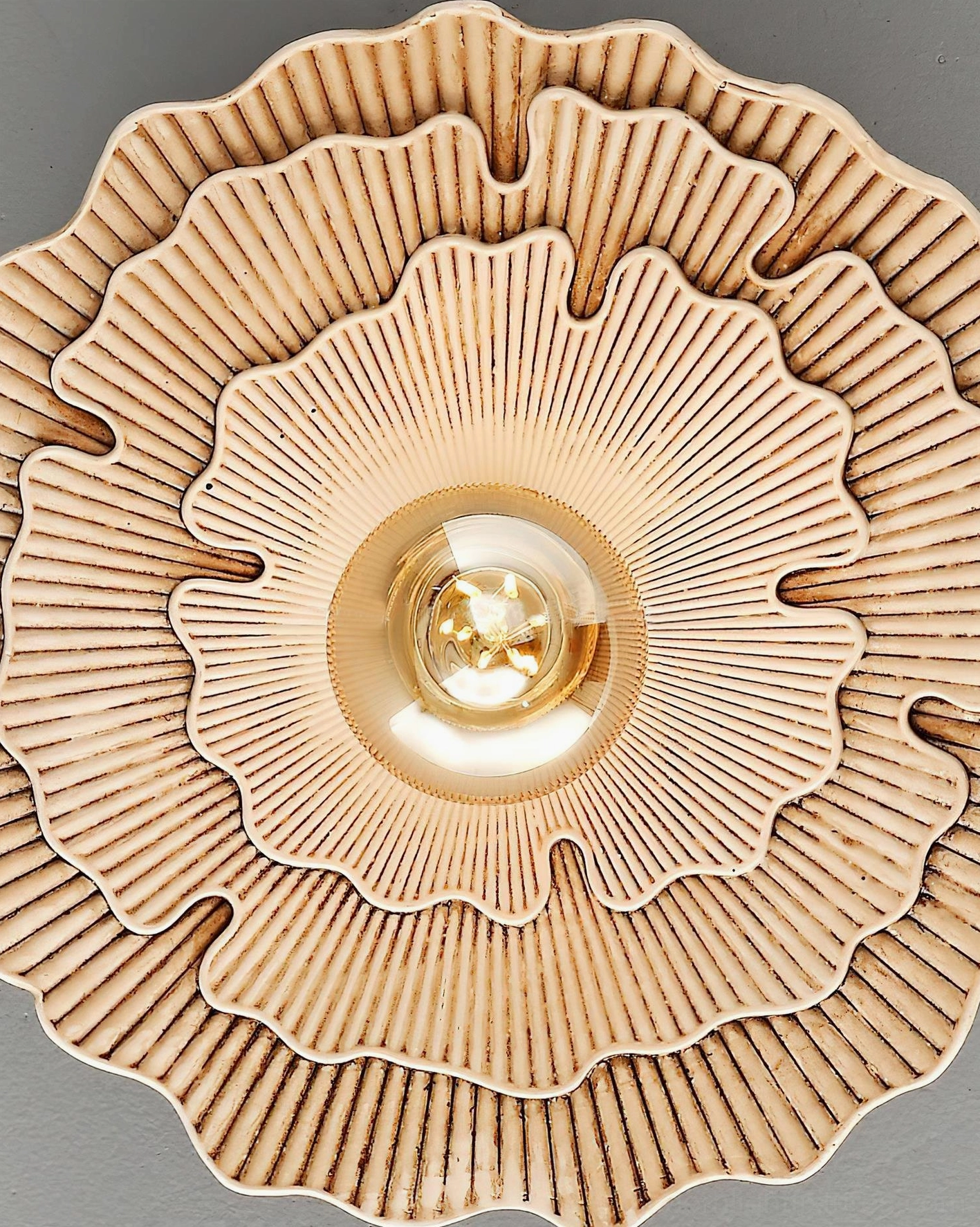 Close-up detail of Myco ceiling light shade texture showing layered carved mushroom gills pattern and ribbed surface, front view