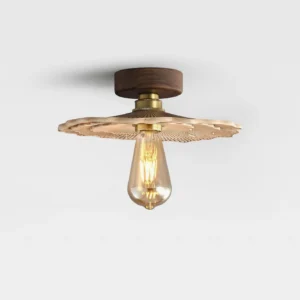 Vintage mushroom ceiling light fixture showing brass hardware joint and detailed ribbed carved shade, side oblique perspective
