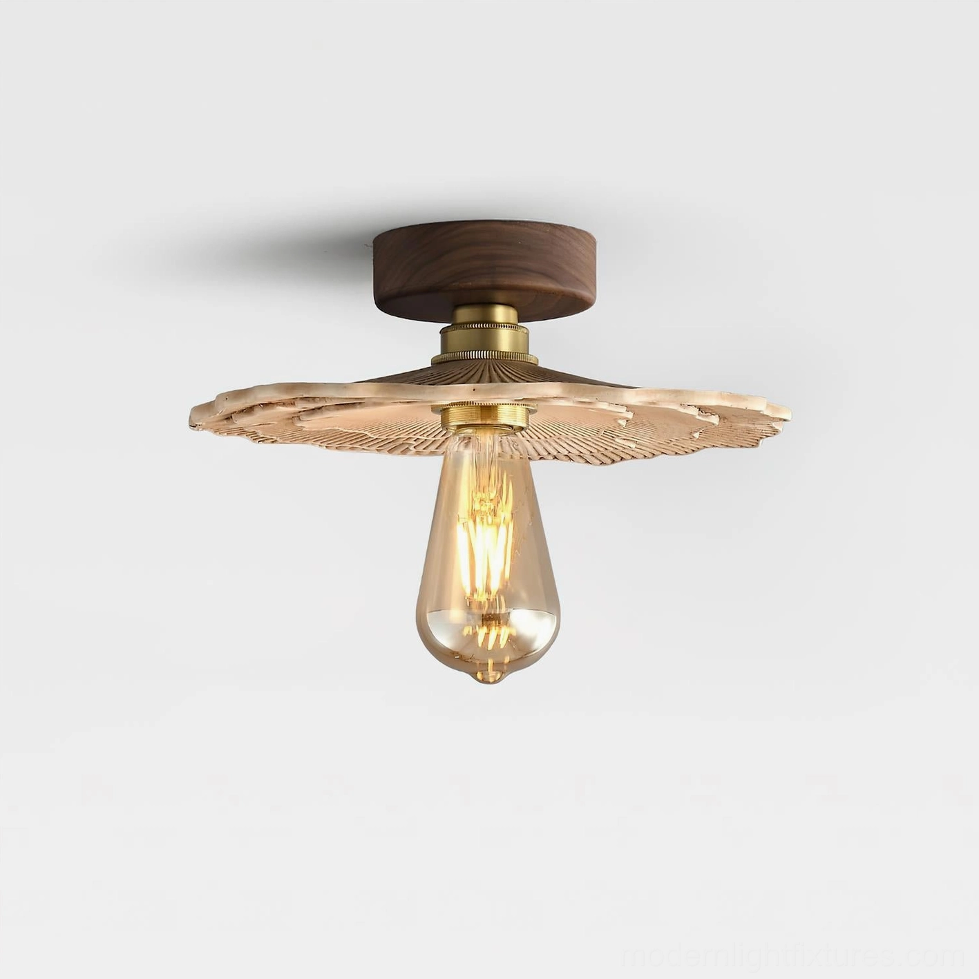 Vintage mushroom ceiling light fixture showing brass hardware joint and detailed ribbed carved shade, side oblique perspective