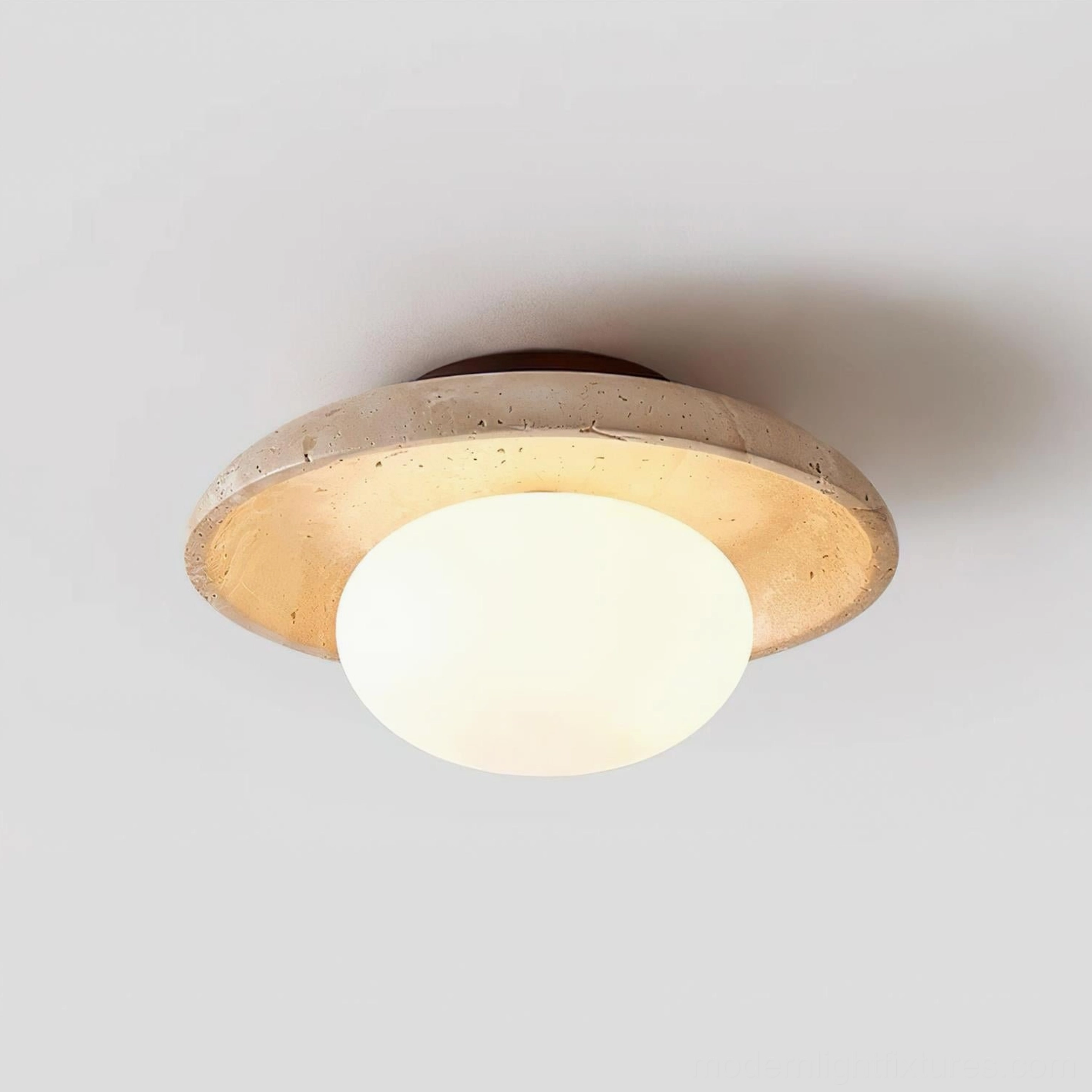 Mylie travertine ceiling light fixture showing even diffusion and soft glow from frosted glass globe design