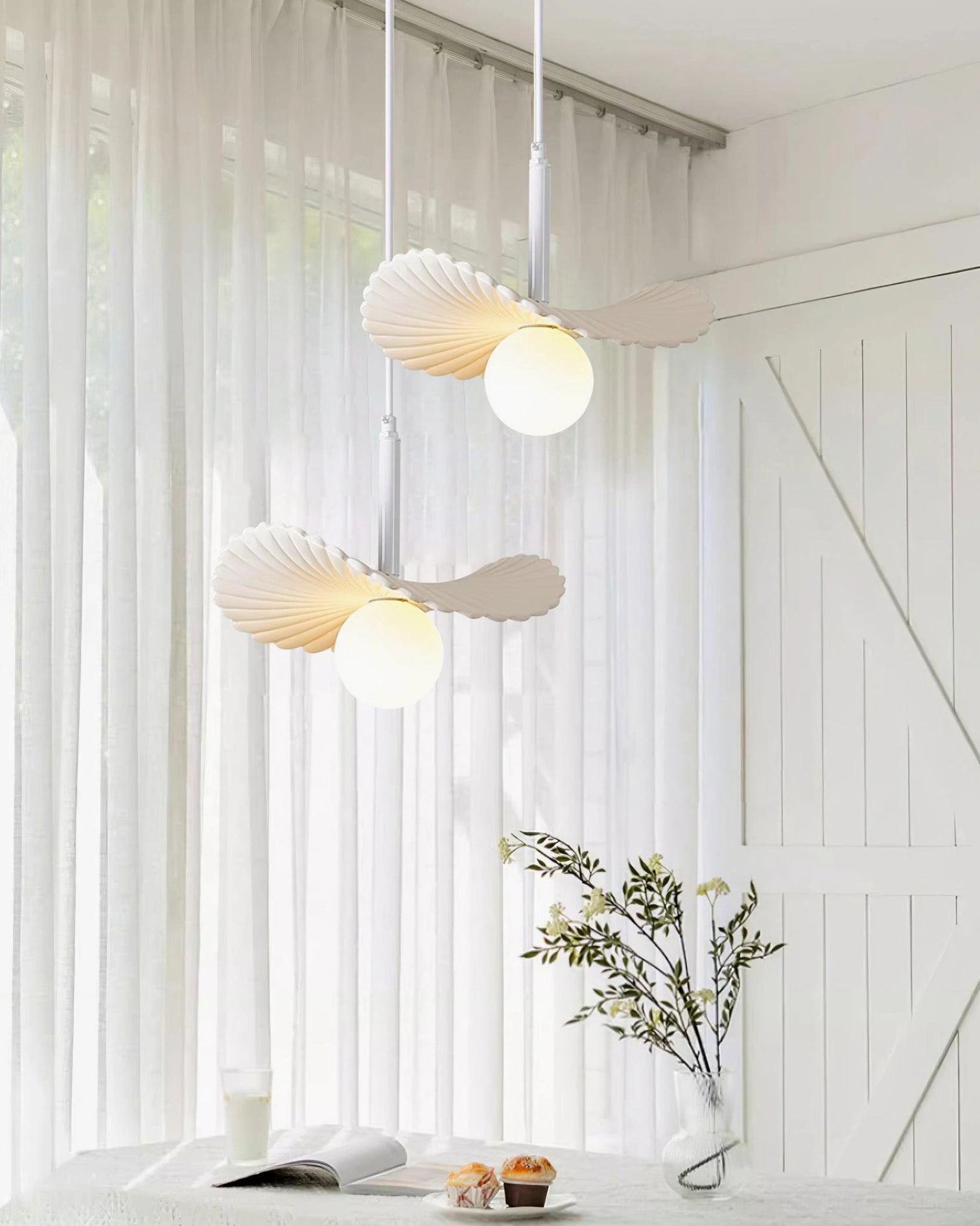 Myrna pendant light with illuminated frosted acrylic showing ambient glow and shadow play, organic biomimetic form highlighted