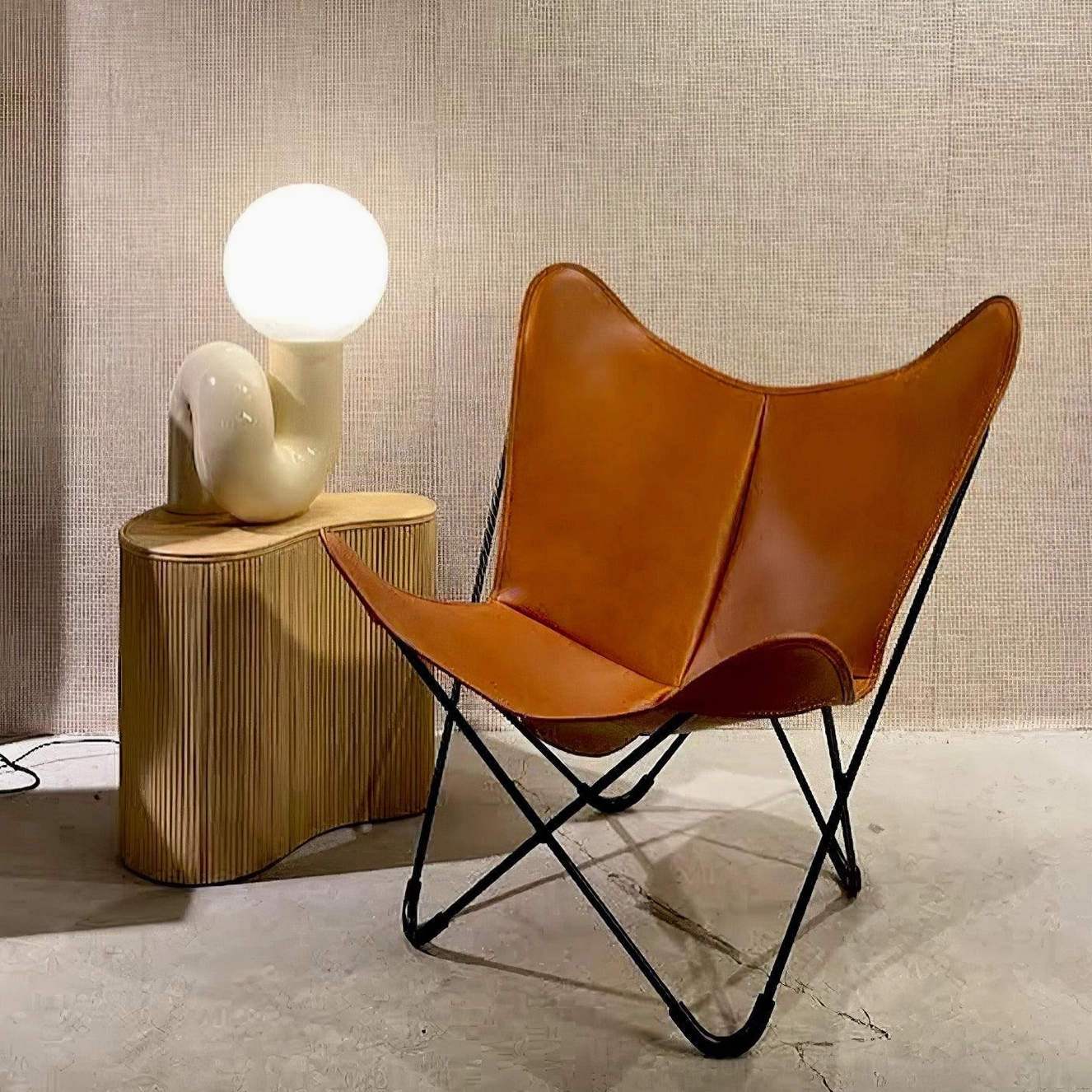 Beige curved ceramic N-shape lamp positioned on wooden side table in contemporary living room lounge